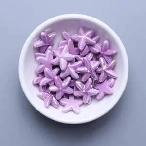 Macro shot of purple glazed ceramic starfish beads for handmade DIY jewelry making
