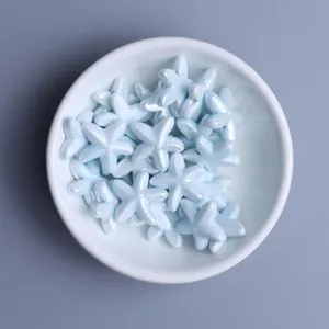 Close-up of light blue glazed starfish ceramic beads for DIY jewelry making and crafts