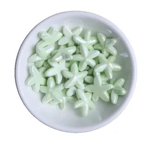 Lustrous light green starfish ceramic beads for DIY handmade jewelry in a white bowl