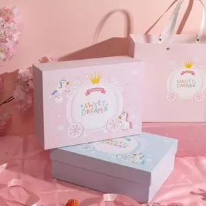Detail of fairy-tale gift boxes with unicorn prints and matching pink paper gift bags