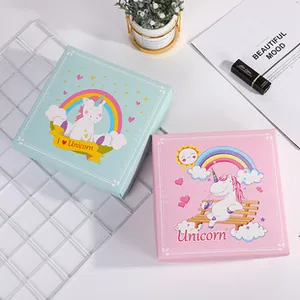 Detail of baby gift boxes featuring cartoon unicorn and rainbow prints in pink and green