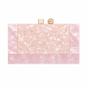 Detail of pink marble textured acrylic clutch with gold metal hardware and square clasp