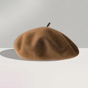 Detail of premium dark brown wool beret showing high-density felt texture and classic top stem