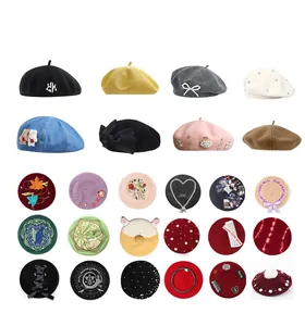 Detailed display of wool berets in various colors with embroidery and pearl decorations