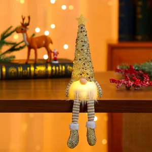 Detail of a glowing Christmas gnome with gold sequin hat and striped dangling legs