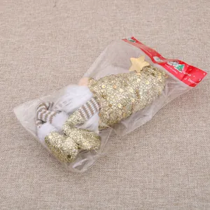Christmas gnome doll in gold sequins with striped knitted legs in clear packaging