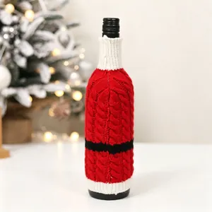 Macro detail of knitted Santa wine bottle cover with belt decor in a festive setting