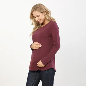 Macro detail of the wine red maternity top showing nursing opening and cotton fabric