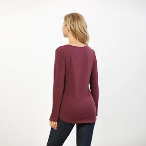 Detail of burgundy nursing top featuring side openings and high-quality elastic fabric