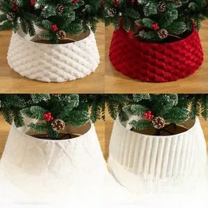 Detail of Christmas tree skirts in red knit and white plush textures for festive decor
