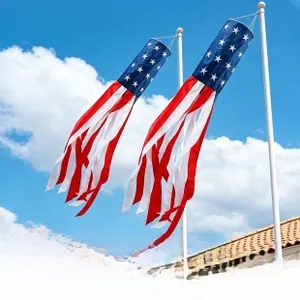 Outdoor American flag windsock with stars and stripes hanging against a blue sky