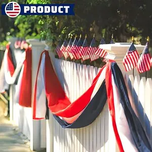 Close-up of patriotic American flag pleated bunting and star flags on white fence