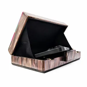 Detailed interior of marble acrylic clutch bag showing black lining and storage space