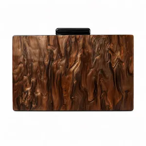 Macro view of brown marble texture acrylic clutch bag with rectangular black metal lock