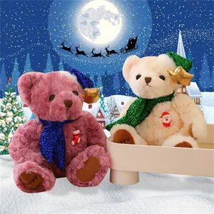 Detail of plush Christmas teddy bears with sequin scarves and festive star hats in snow