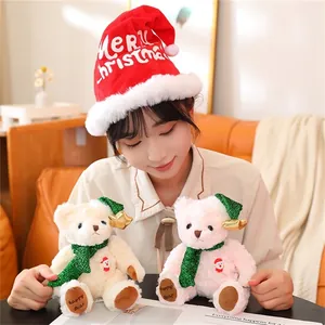 Detail of plush Christmas teddy bears with green hats and scarves held by a person