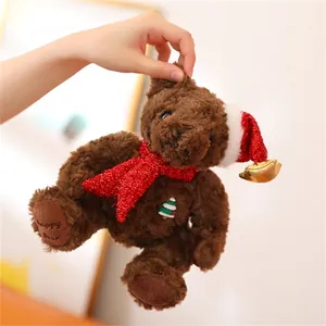 Detail of Christmas teddy bear with festive scarf and happy Bear embroidery on the foot