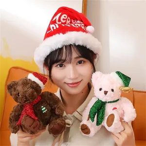 Detail of plush Christmas teddy bears in brown and pink with sequined scarves and festive hats