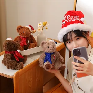 Close-up of three plush Christmas teddy bears with festive scarves and themed embroidery