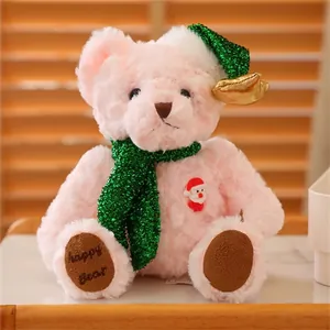 Close-up of pink Christmas teddy bear with green glitter hat and happy bear embroidery