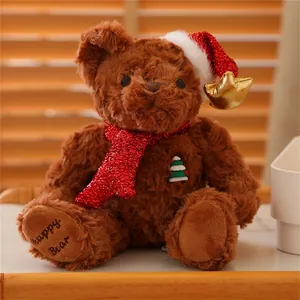 Close-up of brown Christmas teddy bear with red sequin scarf and Happy Bear embroidery
