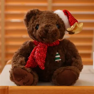 Detail of Christmas teddy bear with red sequin scarf and star hat on wood background