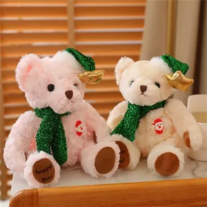 Close-up of pink and cream Christmas teddy bears with sequin scarves and Santa motifs