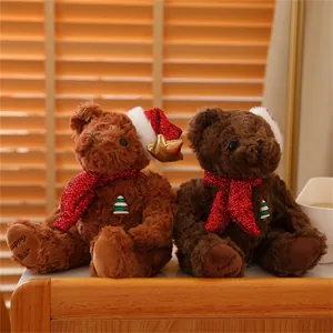 Detail of Christmas teddy bears with red sequin scarves and festive hats in cozy setting