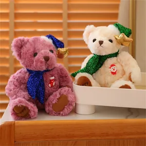 Detail of Christmas teddy bears with sequin hats and festive embroidery on wooden background