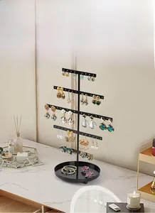 5-tier black metal jewelry stand with round tray displaying earrings and bracelets