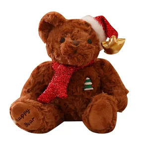 Detailed view of brown plush teddy bear with red sequin scarf and Merry Christmas hat