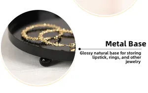 Macro detail of glossy black iron jewelry base with ball-shaped support feet for storage