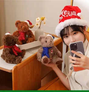 Detail of Christmas teddy bears with sequin scarves and hats held by a model