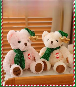 Detailed view of pink and beige Christmas teddy bears with green sequined scarves and hats