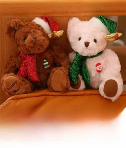 Close-up of plush Christmas teddy bears with sequins hats and festive knitted scarves