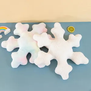 Plush snowflake pillow in soft white and rainbow tie-dye colors for cozy home decoration