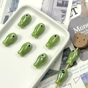 Macro detail of ceramic fish beads for DIY jewelry making on a decorative tray
