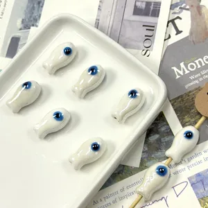 Fish-shaped ceramic beads with blue evil eye pattern for DIY jewelry making