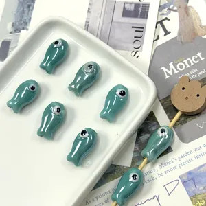 Detailed view of fish-shaped turquoise ceramic beads for DIY jewelry making and crafts