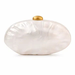 Detail of pearlescent shell-shaped acrylic evening clutch bag with golden metal clasp