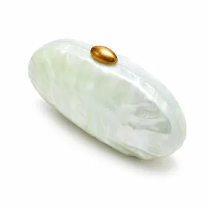 Detailed view of green marble acrylic clutch with elegant golden metal pebble clasp
