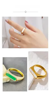 Detail of geometric gold-plated titanium ring with white shell and green resin inlays