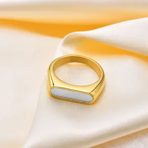 Minimalist gold titanium steel ring with rectangular white shell inlay on silk