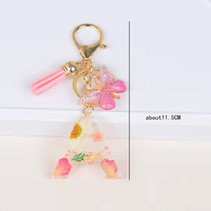 Resin letter A keychain with dried flowers, gold foil, pink tassel and butterfly charm