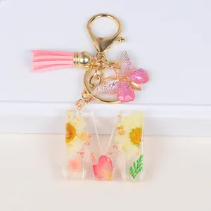 Floral resin letter M keychain with real dried flowers, butterfly charm and pink tassel