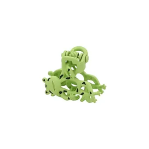 Detail view of funny green frog hair claw clip with black spots and matte finish