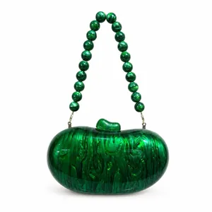 Detailed view of emerald green marbled acrylic clutch bag with beaded handle