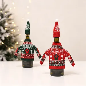 Close-up of knit Christmas wine bottle covers with snowflake patterns and mini hats