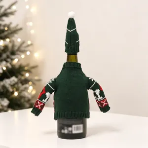 Detailed view of dark green knitted Christmas wine bottle cover with festive patterns