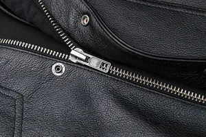 Detailed macro view of black lychee-textured leather vest with silver YKK zippers